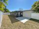 Fenced backyard with a screened-in lanai and concrete patio, perfect for outdoor living at 2607 Verde Ln, Winter Park, FL 32792