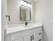 Stylish bathroom vanity with modern lighting, a sleek mirror, and a white countertop and cabinets at 2607 Verde Ln, Winter Park, FL 32792