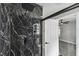 Bathroom featuring a stunning black marble tiled shower with glass enclosure and premium fixtures at 2607 Verde Ln, Winter Park, FL 32792