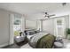 Comfortable bedroom with neutral tones, large window, and modern ceiling fan, creating a relaxing space at 2607 Verde Ln, Winter Park, FL 32792