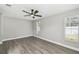 Well-lit bedroom with gray vinyl floors, showcasing natural light from the windows and neutral wall colors at 2607 Verde Ln, Winter Park, FL 32792