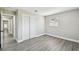 A bedroom with neutral walls, light wood floors, a closet, and a window overlooking the front yard at 2607 Verde Ln, Winter Park, FL 32792