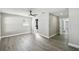 Bright bedroom featuring sleek gray flooring and an en suite bathroom, with a modern ceiling fan at 2607 Verde Ln, Winter Park, FL 32792