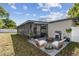 Enjoy outdoor living on this beautiful patio with a fire pit, grill, and seating near the screened lanai at 2607 Verde Ln, Winter Park, FL 32792