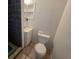 Bathroom with toilet, sink, storage, and tile shower at 911 Oak Dr, Leesburg, FL 34748