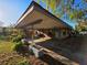 Covered carport featuring sturdy support columns, offering ample space for parking and sheltering vehicles at 911 Oak Dr, Leesburg, FL 34748