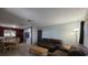 Open-concept living room with tile flooring and warm natural light, flowing into the adjacent dining and kitchen areas at 911 Oak Dr, Leesburg, FL 34748