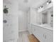 Bathroom featuring shower with decor, dual vanity, and wood-look floors at 44 Cedar Tree Dr, Ocala, FL 34472