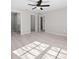 Bedroom featuring hard wood floors, multiple doorways, and a ceiling fan at 44 Cedar Tree Dr, Ocala, FL 34472