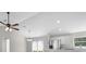 Living room with hardwood floors, ceiling fan, view of kitchen, chandelier, and recessed lighting at 44 Cedar Tree Dr, Ocala, FL 34472