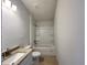 Bright bathroom with a single vanity, granite counter, and a shower-tub combination at 4498 Sw 90Th Lane Rd, Ocala, FL 34476