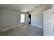 Bedroom with a vaulted ceiling, neutral walls, and a doorway leading to another room at 4498 Sw 90Th Lane Rd, Ocala, FL 34476