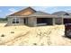 An unfinished single-Gathering home with concrete walls, attached garage, and a newly installed gray shingle roof at 4498 Sw 90Th Lane Rd, Ocala, FL 34476