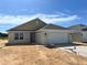 Newly built single-Gathering home featuring a two-car garage and neutral-toned exterior at 4498 Sw 90Th Lane Rd, Ocala, FL 34476