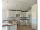 Bright kitchen featuring white cabinets, granite counters, and stainless steel sink at 4498 Sw 90Th Lane Rd, Ocala, FL 34476
