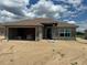 Unfinished exterior with attached garage and block construction under a cloudy sky at 4516 Sw 90Th Lane Rd, Ocala, FL 34476