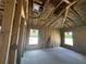 Bedroom under construction, framed walls, and large windows with insulation at 4516 Sw 90Th Lane Rd, Ocala, FL 34476