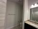 A bathroom featuring a shower with glass doors, a toilet, and a sink with granite counters at 4528 Sw 90Th Lane Rd, Ocala, FL 34476