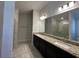 Bathroom with a glass shower and granite counters, dual sinks, and modern lighting at 4528 Sw 90Th Lane Rd, Ocala, FL 34476