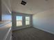 Bright, carpeted bedroom featuring two windows that offer plenty of natural light at 4528 Sw 90Th Lane Rd, Ocala, FL 34476