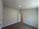 Carpeted bedroom with neutral walls, a bright window, and a five-panel door at 4528 Sw 90Th Lane Rd, Ocala, FL 34476
