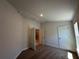 Bright, carpeted bedroom seen through an open doorway featuring neutral walls and carpet at 4528 Sw 90Th Lane Rd, Ocala, FL 34476