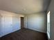 Carpeted bedroom with neutral walls, a bright window, and ample closet space at 4528 Sw 90Th Lane Rd, Ocala, FL 34476