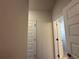 Hallway with white doors and neutral-colored walls at 4528 Sw 90Th Lane Rd, Ocala, FL 34476