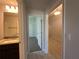 Hallway showcasing tile floors with views of a granite-countered bathroom and another bedroom at 4528 Sw 90Th Lane Rd, Ocala, FL 34476