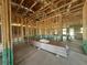 Interior framing of a home shows drywall stacked on the floor awaiting installation at 4528 Sw 90Th Lane Rd, Ocala, FL 34476