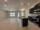 Open concept view of the kitchen with granite counters, an island, stainless steel appliances, and a large living area at 4528 Sw 90Th Lane Rd, Ocala, FL 34476