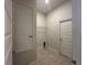 A well-lit laundry room featuring tile flooring and wire shelving at 4528 Sw 90Th Lane Rd, Ocala, FL 34476