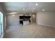 Open-concept living and dining area with kitchen featuring dark cabinets and an island at 4528 Sw 90Th Lane Rd, Ocala, FL 34476