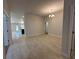 A spacious living area with tile flooring, a decorative chandelier, and an open floor plan at 4528 Sw 90Th Lane Rd, Ocala, FL 34476