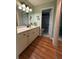 Well-maintained bathroom with vanity, mirror, and shower at 9090 Se 135Th Loop, Summerfield, FL 34491