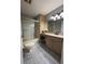 Well-lit bathroom featuring marble flooring, vanity with sink, and glass-enclosed shower at 9090 Se 135Th Loop, Summerfield, FL 34491