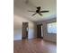 Comfortable living room with laminate floors, a ceiling fan, and natural light at 9090 Se 135Th Loop, Summerfield, FL 34491