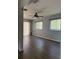 Inviting living room featuring stylish flooring, a ceiling fan, and natural light from the windows at 9090 Se 135Th Loop, Summerfield, FL 34491