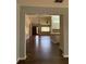 Bright living room showcasing modern flooring, chandelier, and seamless flow to the kitchen area at 9090 Se 135Th Loop, Summerfield, FL 34491