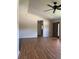 Inviting living room with wood-look floors, ceiling fan, and view of the entrance at 9090 Se 135Th Loop, Summerfield, FL 34491