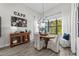 Bright dining area with hardwood floors, large window, cafe wall decor and decorative chandelier at 9307 San Jose Blvd, Howey In The Hills, FL 34737