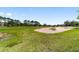 Expansive golf course featuring a large sand trap and well-maintained green at 9307 San Jose Blvd, Howey In The Hills, FL 34737