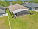 Aerial view of a well-kept backyard with a screened patio and lush lawn at 1201 Creekview Ct, St Cloud, FL 34772