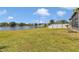 Expansive backyard with lush grass and a serene lake view perfect for outdoor enjoyment at 1201 Creekview Ct, St Cloud, FL 34772