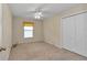 Bedroom featuring carpet, a ceiling fan, closet, and a window with blinds at 1201 Creekview Ct, St Cloud, FL 34772