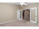 Bright, carpeted bedroom features double doors and a ceiling fan at 1201 Creekview Ct, St Cloud, FL 34772