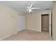 Beige bedroom with carpet, ceiling fan, double closet, and natural light from the window at 1201 Creekview Ct, St Cloud, FL 34772