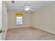 Bedroom featuring carpet, ceiling fan, closet, and a window with blinds and curtains at 1201 Creekview Ct, St Cloud, FL 34772