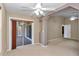 Bedroom with large sliding glass doors, neutral walls, carpet, and ceiling fans offer a comfortable atmosphere at 1201 Creekview Ct, St Cloud, FL 34772