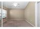 Carpeted bedroom with window, ceiling fan, and neutral paint at 1201 Creekview Ct, St Cloud, FL 34772